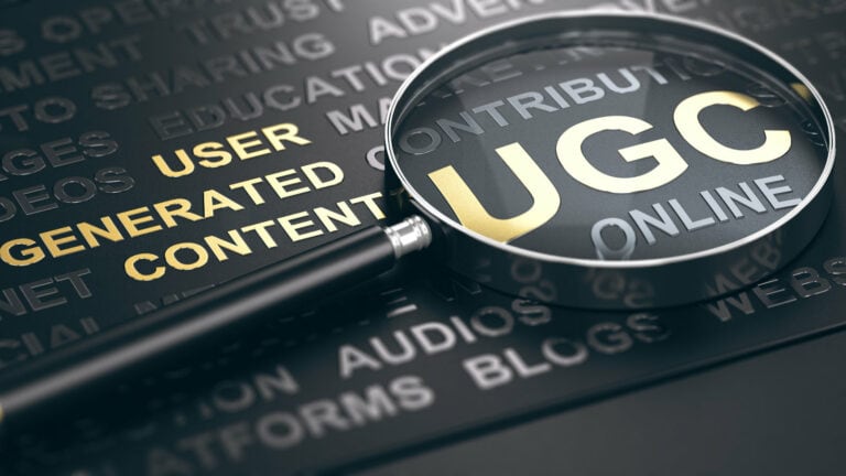 A compelling image of the letters UGC under a magnifying glass, representing the in-depth exploration of User-Generated Content in the article. The image visually underscores the focus on the role and value of UGC Content Creators in the digital world.